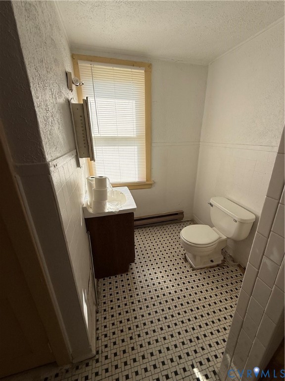 White toilet and a vanity with a white countertop