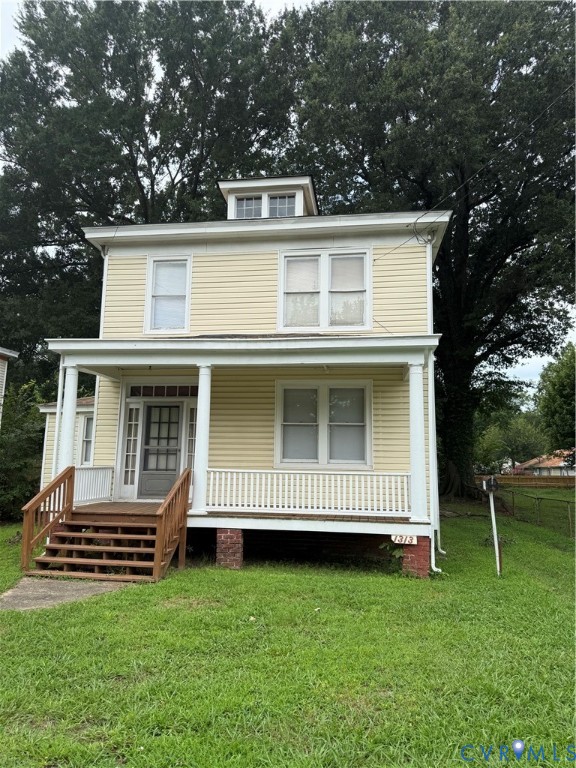 Two-story residence with siding exterior, covered front porch, and dormer window Two-story residence with siding exterior, covered front porch, and dormer window