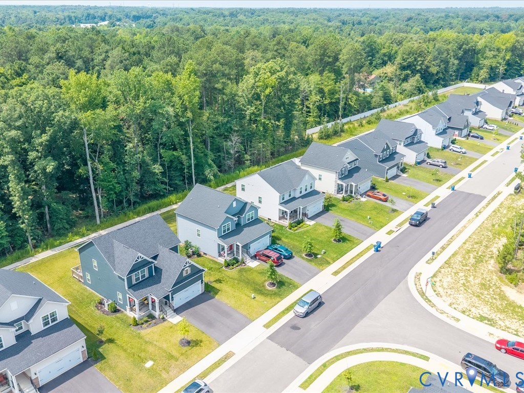 Residential street with uniform sidewalks and manicured lawns