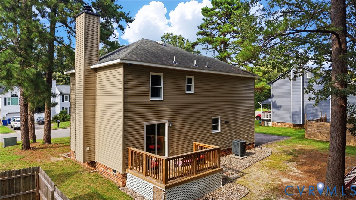 Exterior featuring horizontal siding, a tall chimney, a wood deck with railings, and a sliding glass door Exterior featuring horizontal siding, a tall chimney, a wood deck with railings, and a sliding glass door