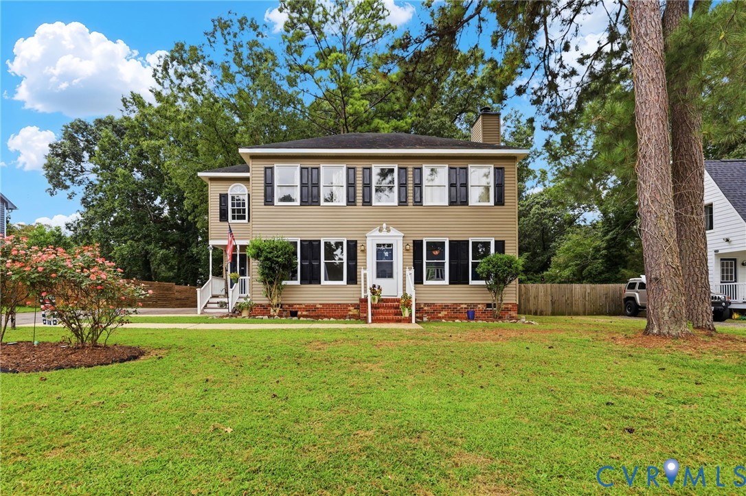 Two-story exterior with siding, a front porch, and a dormer window Two-story exterior with siding, a front porch, and a dormer window