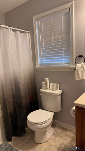 Window with horizontal blinds, white toilet, and tile flooring