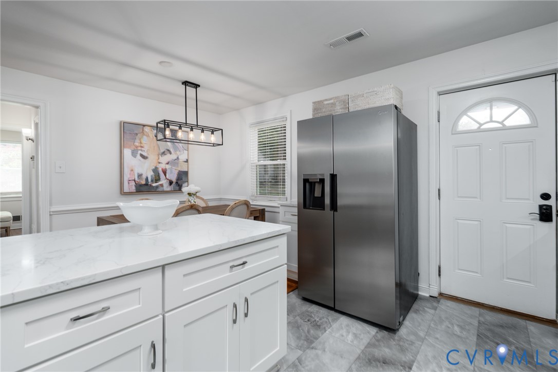 White paneled door with an arched window accent