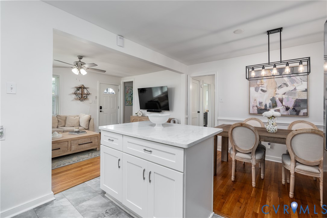 Kitchen island with white cabinetry and light-colored countertop