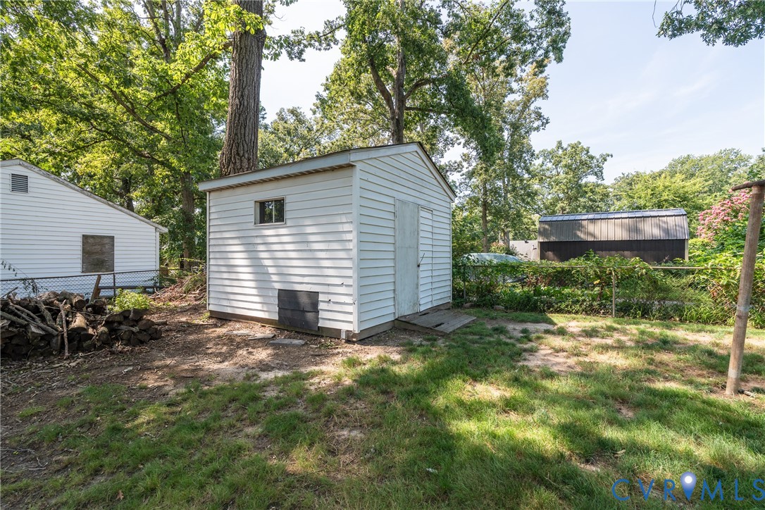 White vinyl siding shed with an exterior window