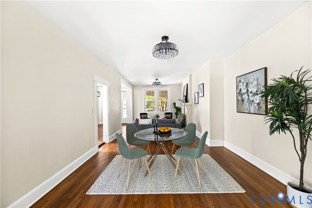 Rich wood-finish flooring, light neutral wall paint, and a crystal-detail semi-flush mount ceiling fixture Rich wood-finish flooring, light neutral wall paint, and a crystal-detail semi-flush mount ceiling fixture