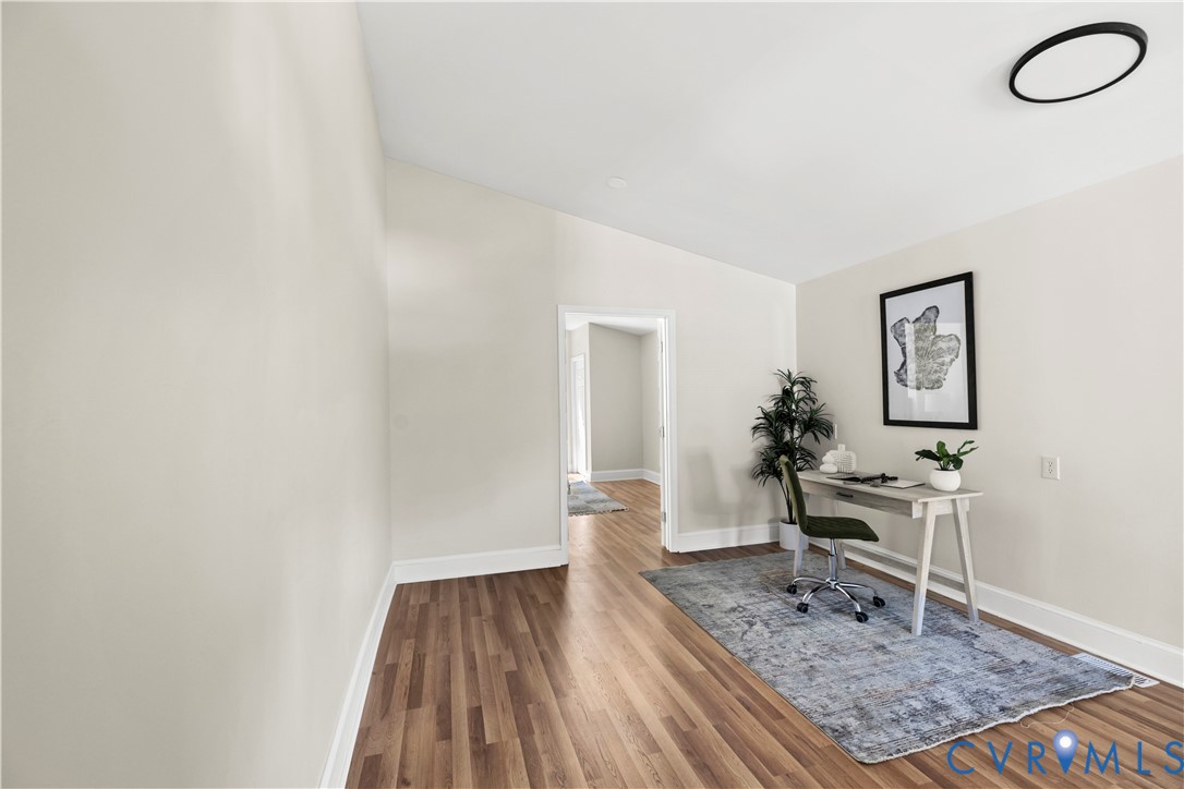 Wood-finish flooring, white wall tones, and an accent wall