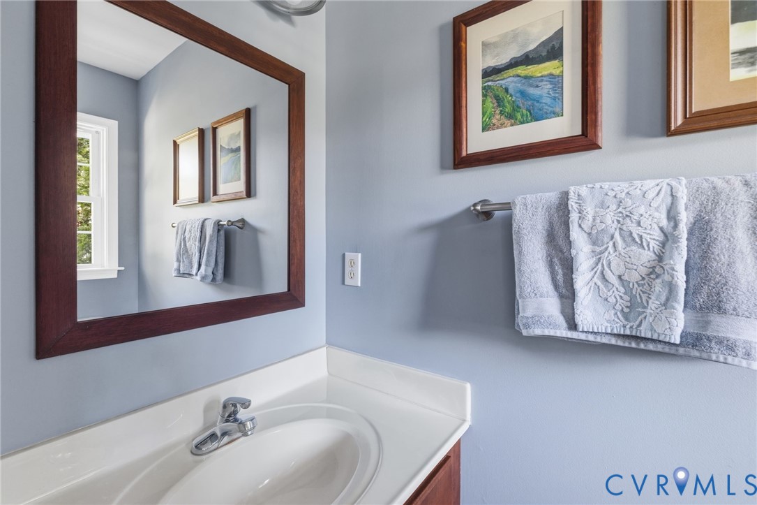 Vanity with an integrated sink, polished chrome faucet, and a white countertop