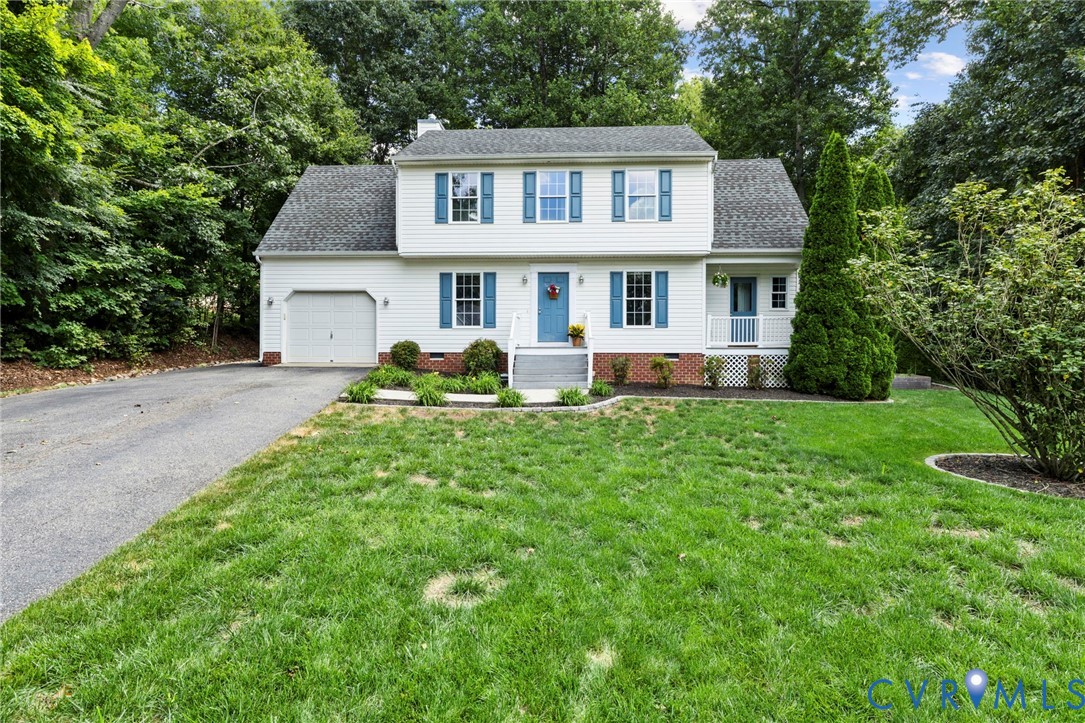 Two-story residence with white siding, blue shutters, and a single-car garage Two-story residence with white siding, blue shutters, and a single-car garage
