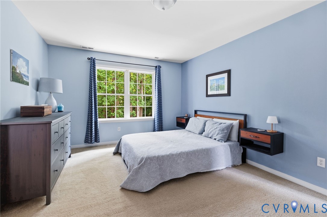 Light blue wall paint, neutral carpet, and a white window frame with multiple panes