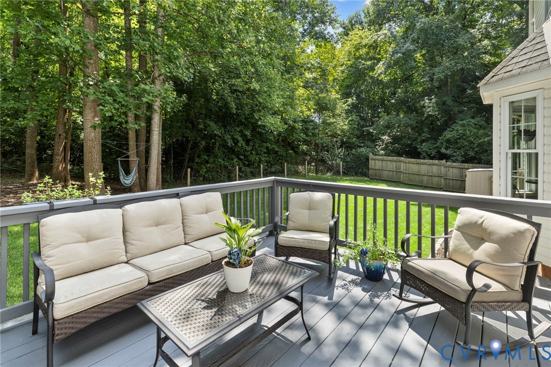 Expansive wooden deck with a gray finish, featuring a surrounding railing