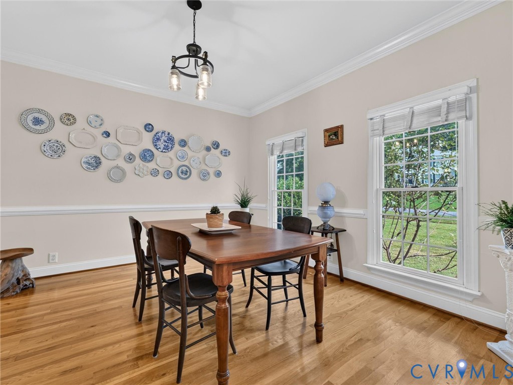 Bright Dining Room with Crown Molding & Chair Railing
