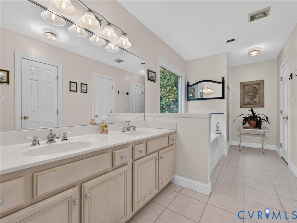 Primary Bath with tile floor and double vanities!
