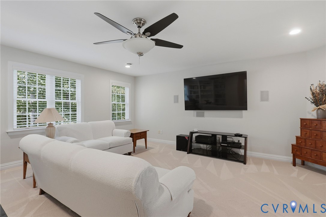 second floor entertaining space with entry to the third floor bonus room and walk in attic