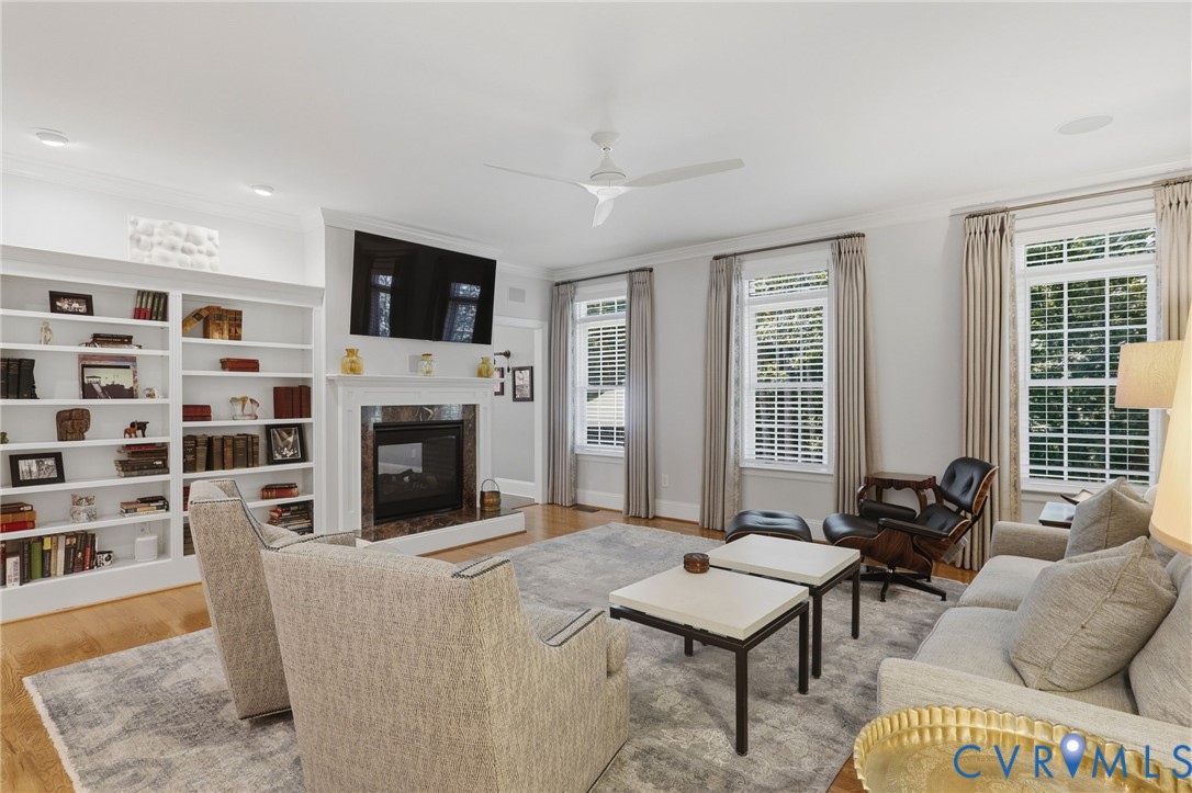 Spacious entertaining space featuring built in's and a double sided  gas fireplace.
