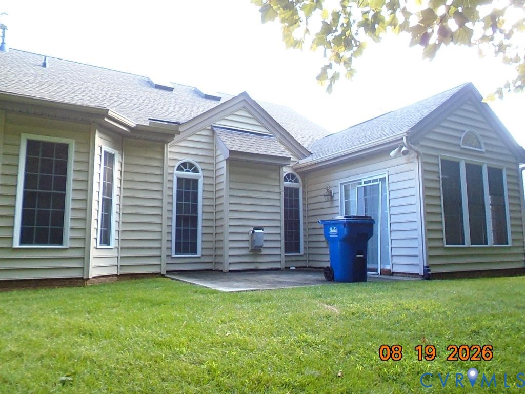 Exterior with horizontal siding, a patio area, multiple windows, and a sliding glass door Exterior with horizontal siding, a patio area, multiple windows, and a sliding glass door