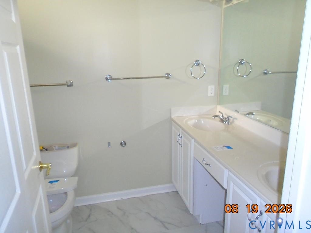 Dual vanity with integrated sinks, full-width mirror, and chrome fixtures