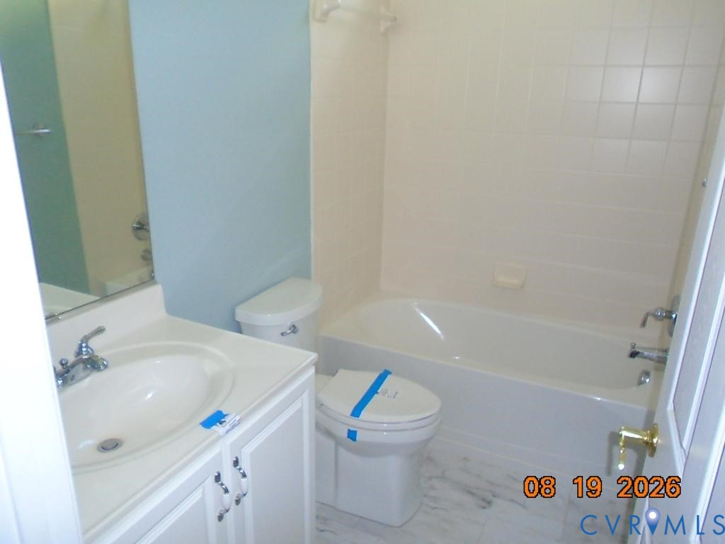 White vanity with dual-handle faucet and integrated sink