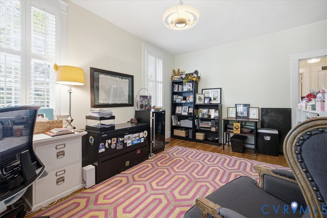 Hardwood flooring throughout, white plantation shutters, built-in recessed lighting, and a contemporary ceiling fixture