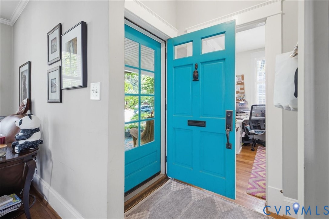 Vibrant front door with transom windows and a black door knocker Vibrant front door with transom windows and a black door knocker