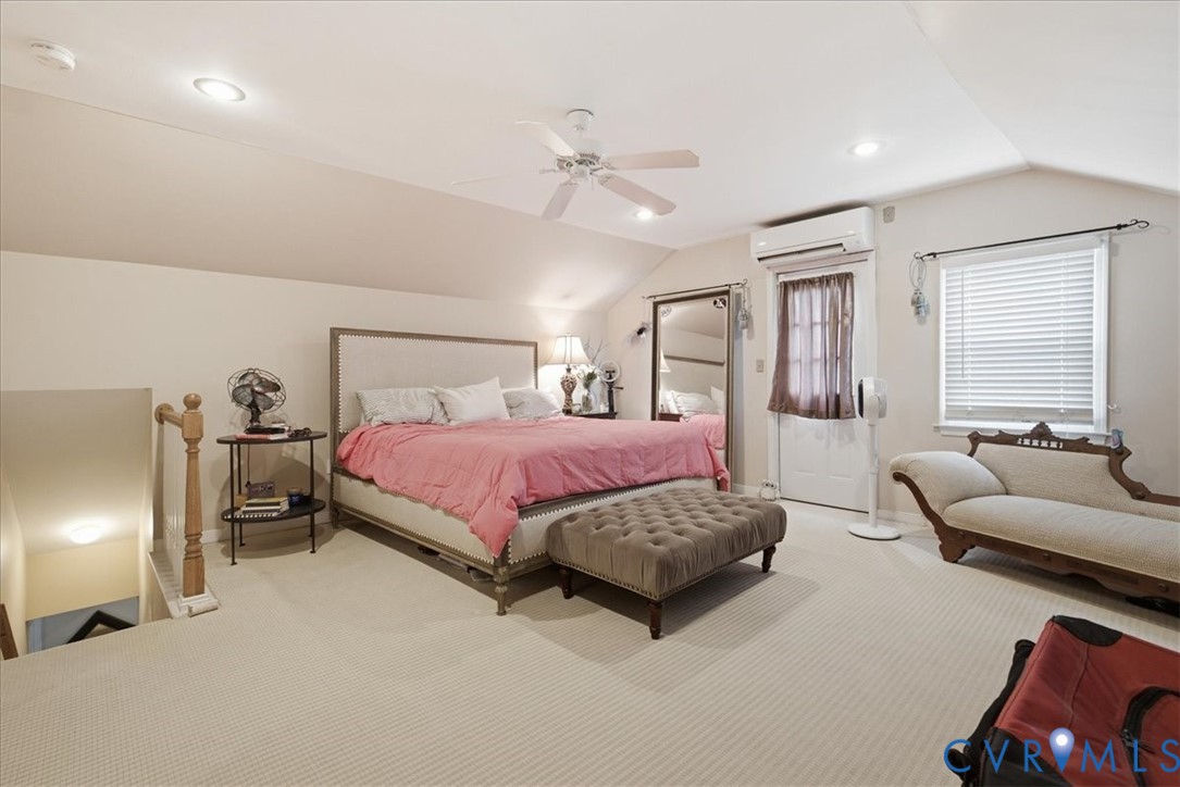 Second level Carpeted flooring, sloped ceiling with recessed lighting, ceiling fan, window with blinds, and a built-in split air conditioning unit