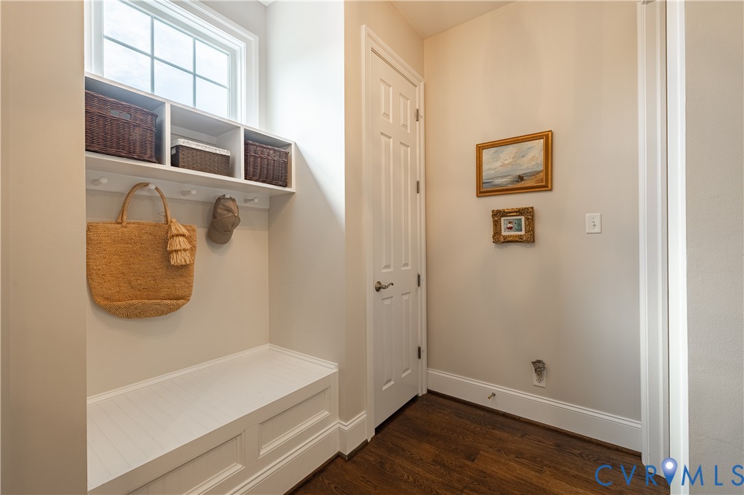 Built-in bench with storage, upper shelving, and wall-mounted hooks