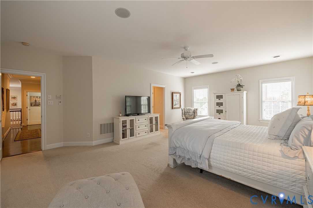 Recessed lighting, ceiling fan, carpeted flooring, multiple windows, and neutral wall tones