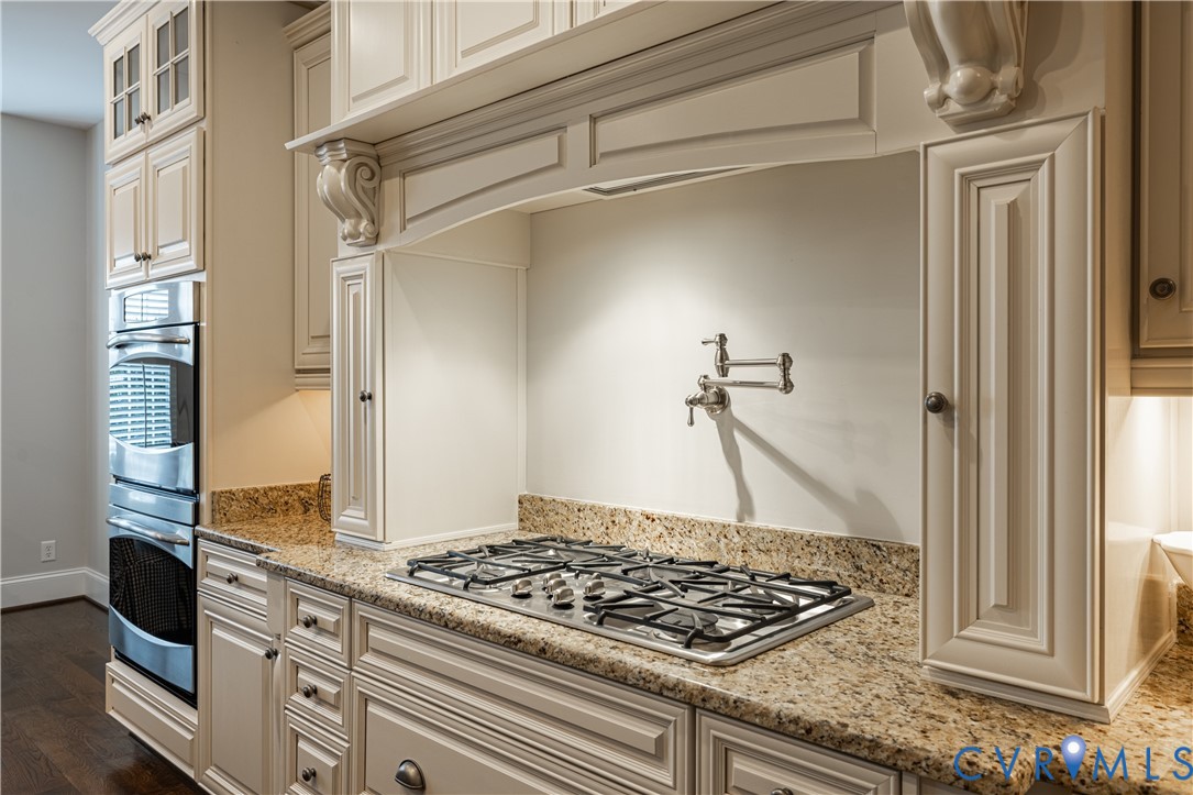 Built-in stainless steel double ovens, gas range, wall-mounted pot filler