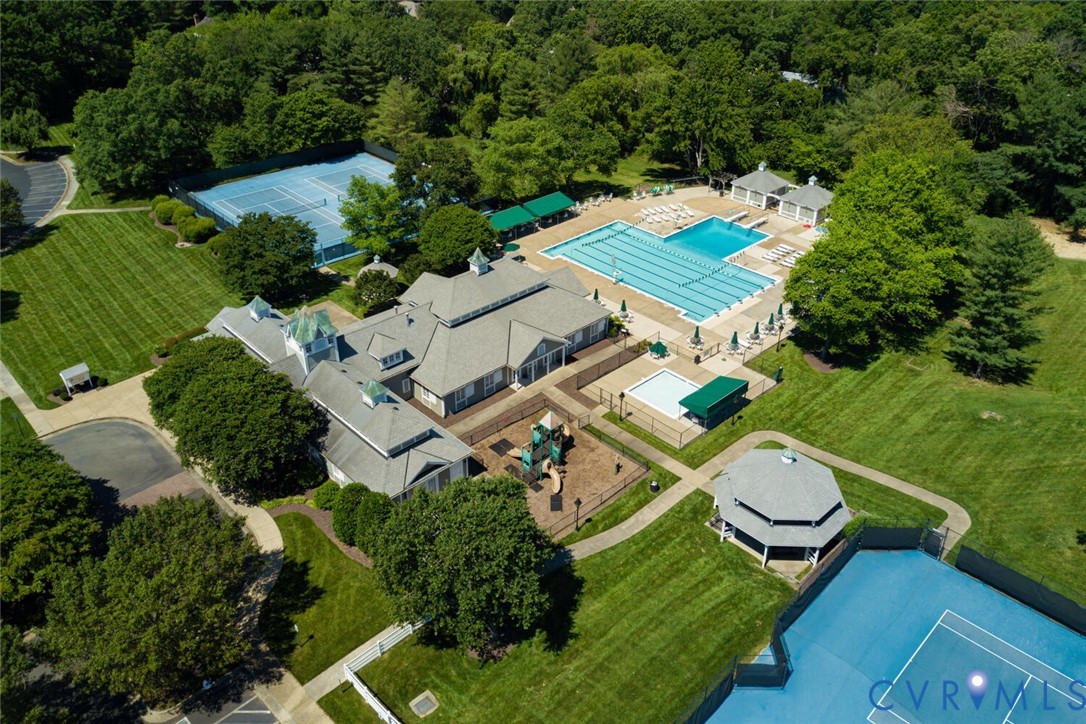 Extensive outdoor amenities featuring multiple tennis courts, a large swimming pool, a separate wading pool, a shaded gazebo, and a children's play area
