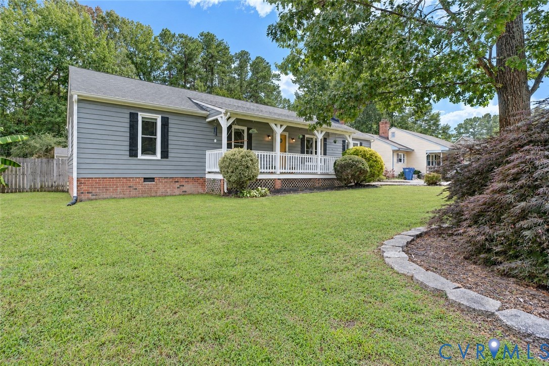 Ranch-style exterior with gray siding and brick foundation