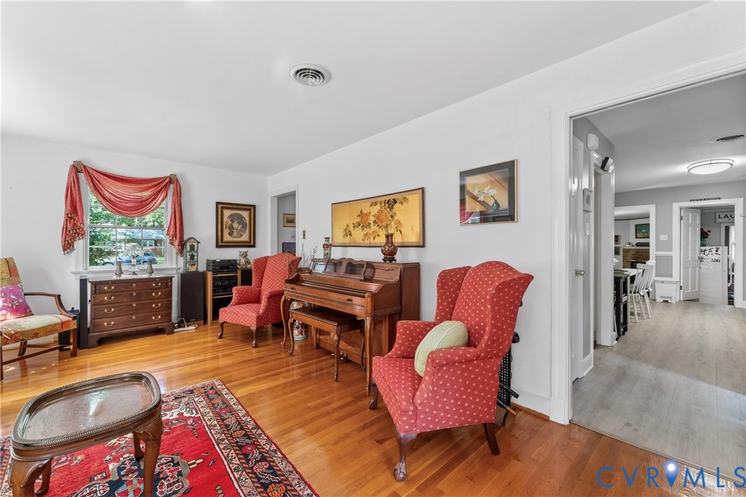 Hardwood flooring, painted white walls, recessed lighting, and a white window frame
