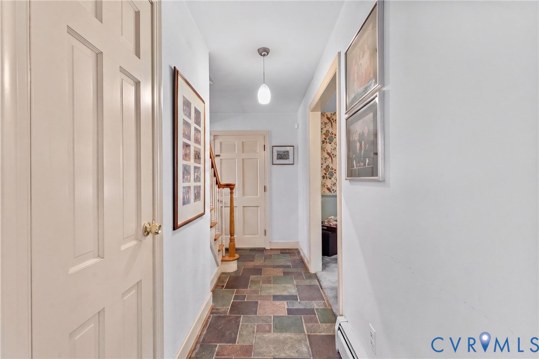 Multi-tone slate tile flooring with light-colored walls and white trim