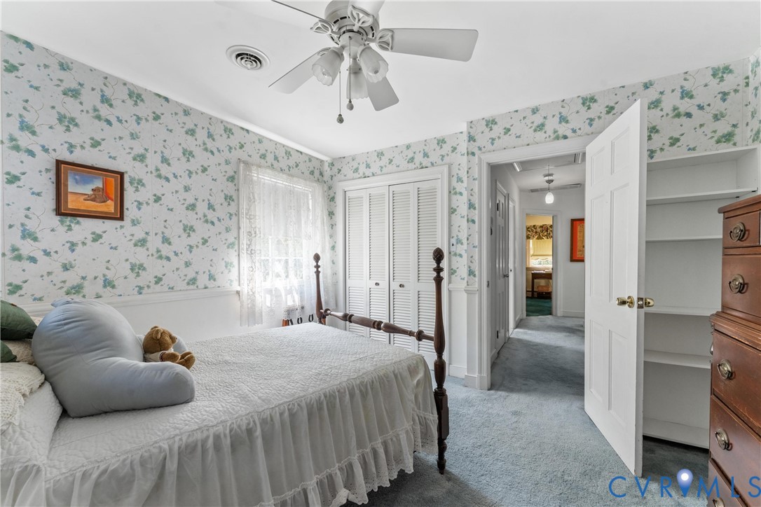 Recessed lighting, ceiling fan, built-in shelving, carpet flooring, and paneled doors