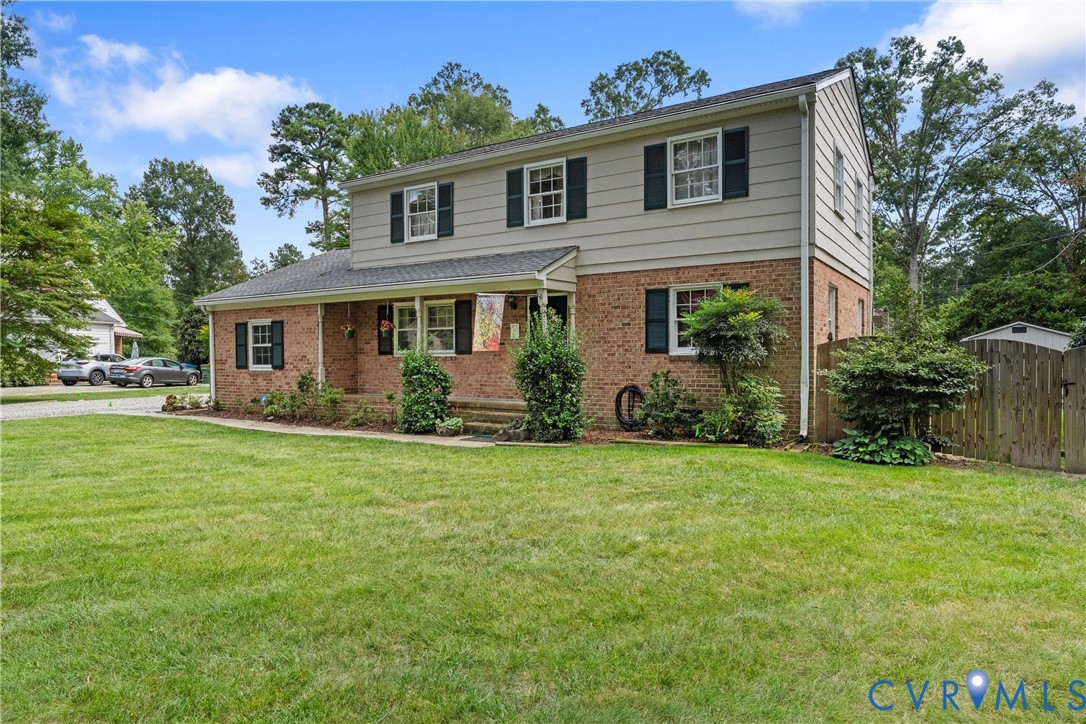 Brick and siding exterior with a covered front porch and dark shutters Brick and siding exterior with a covered front porch and dark shutters