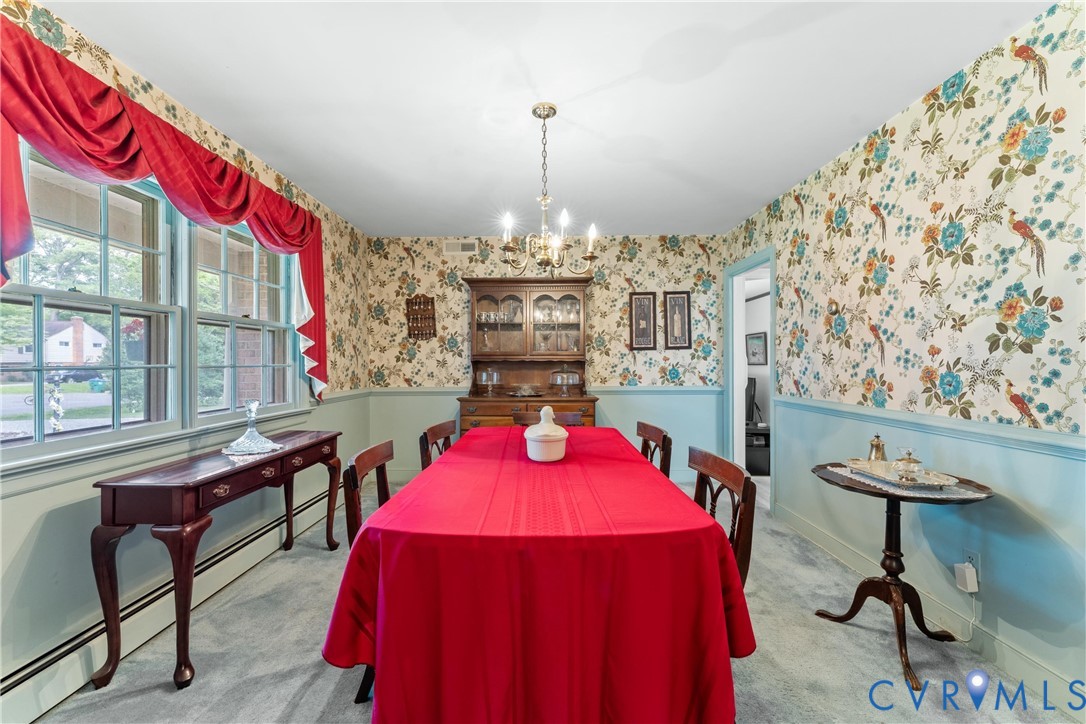 Chandelier lighting, patterned wallpaper, picture frame molding, double-hung windows