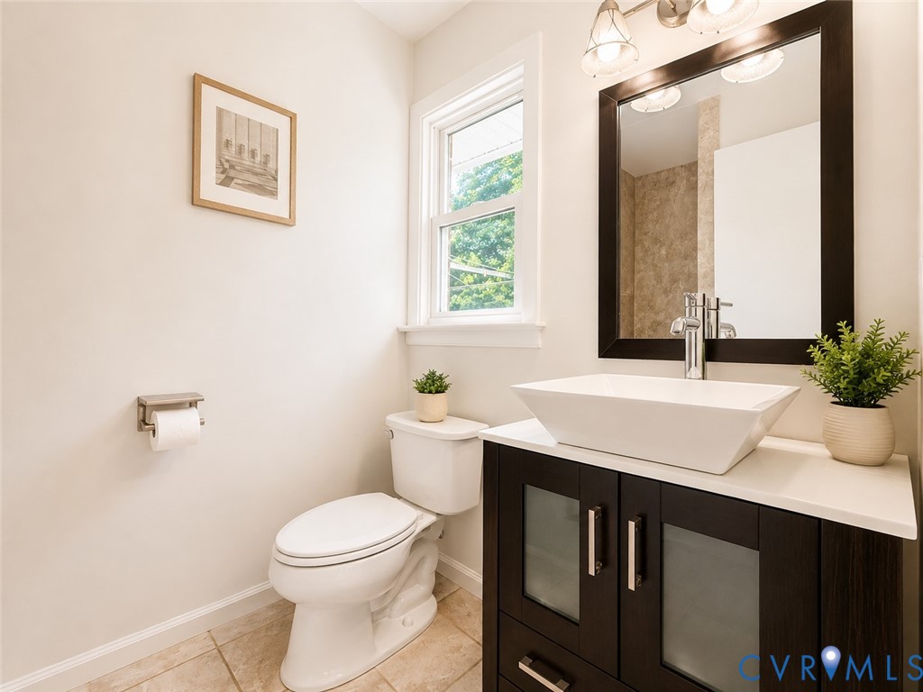 Modern vanity with a rectangular vessel sink, dark wood-finish cabinetry, and a chrome faucet