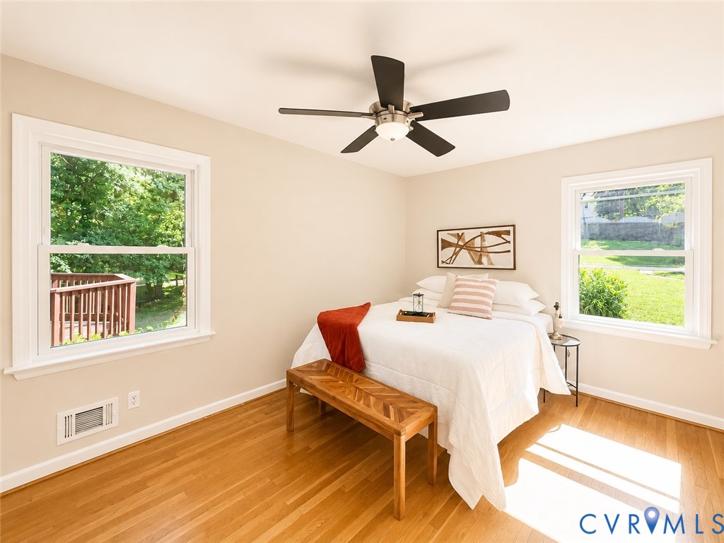 Recessed lighting, ceiling fan, wood-finish flooring, and white trim windows