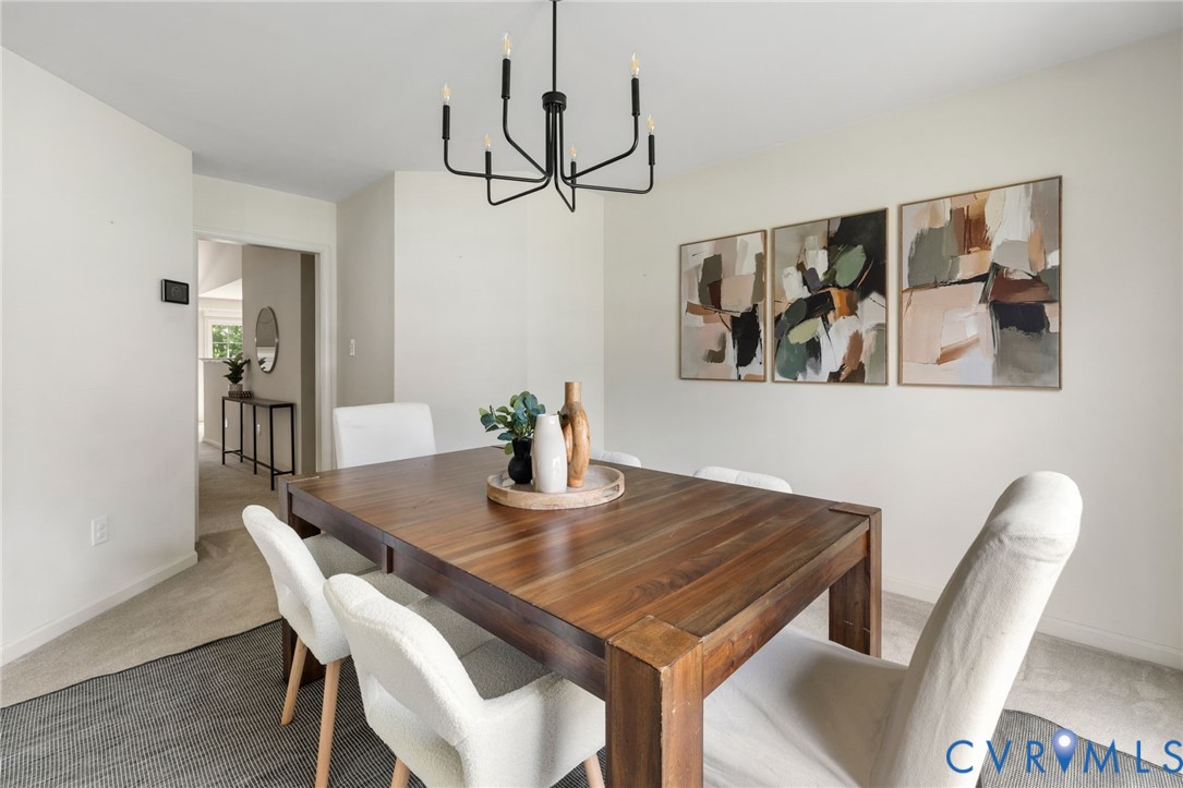 Dining area featuring a contemporary black chandelier, recessed lighting, and neutral wall paint