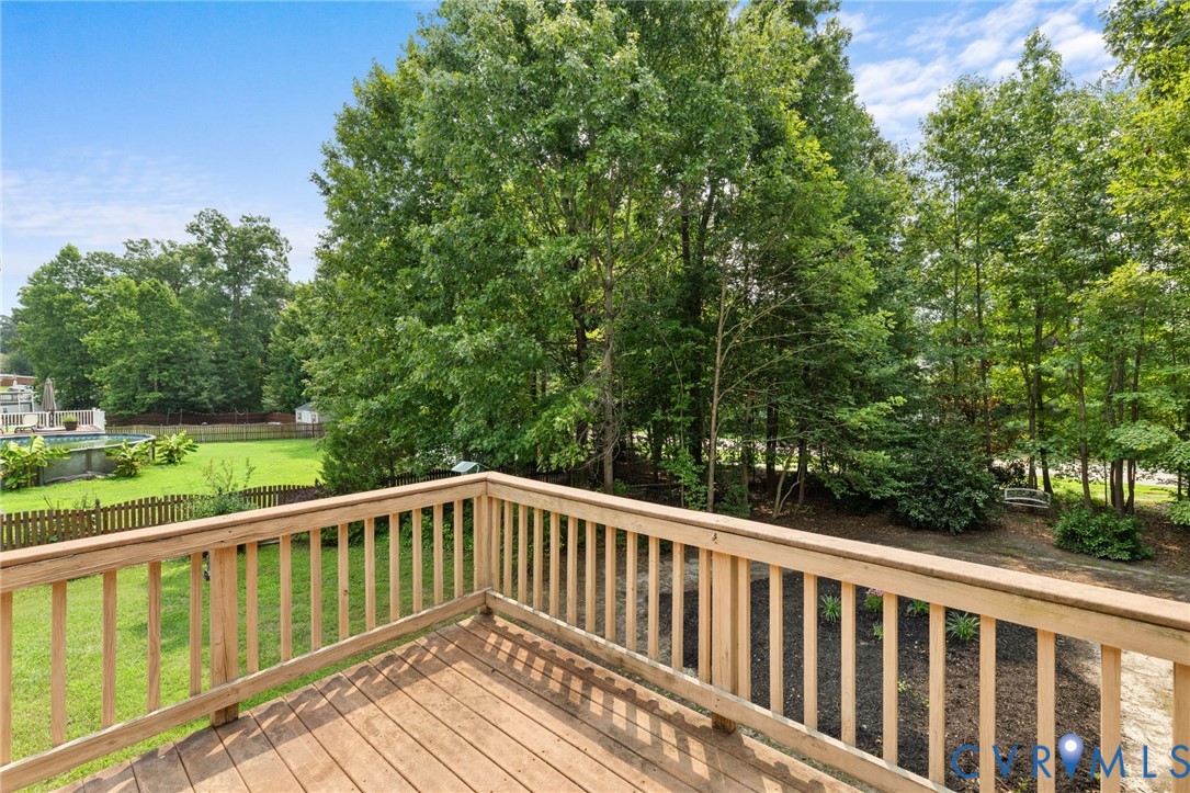 Expansive wood deck with a natural finish, featuring a surrounding wood railing