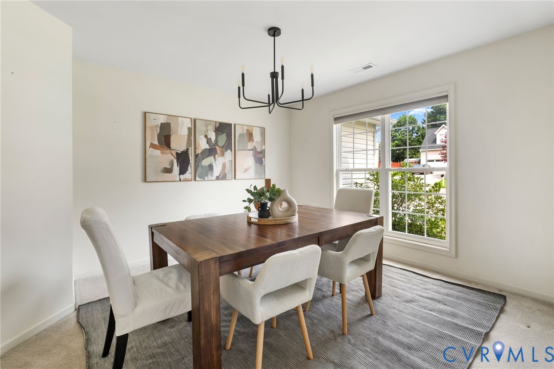 Recessed lighting, wood-finish flooring, and a large window with natural light
