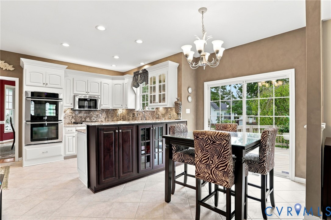 Open kitchen and breakfast area offer plenty of space for everyday dining.