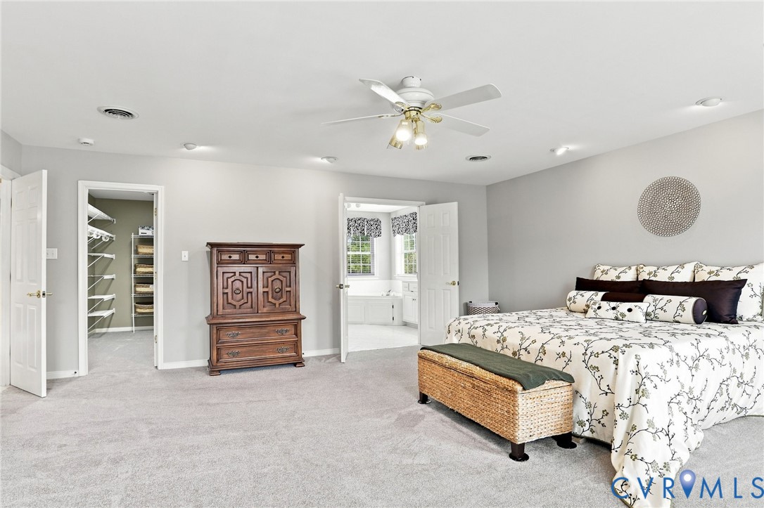 Another view highlights the generous proportions of the primary suite, along with a walk-in closet and en-suite bath.