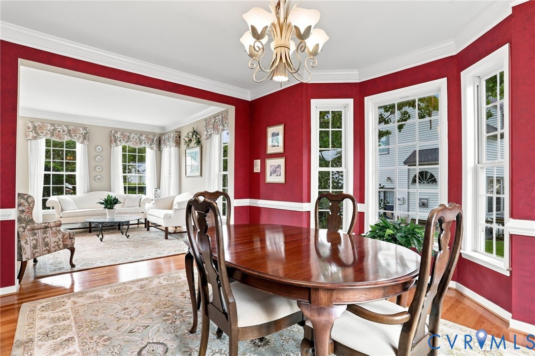 Spacious formal dining room features hardwood floors, crown molding, chair rail, and plenty of natural light
