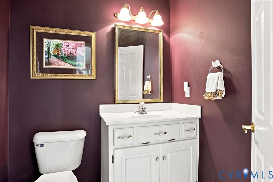 Convenient first-floor powder room with a spacious vanity and classic finishes.