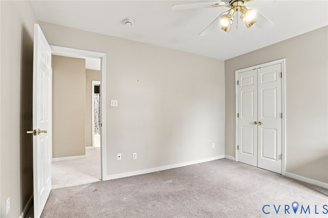 Another view of the third bedroom highlights its generous size and double-door closet.