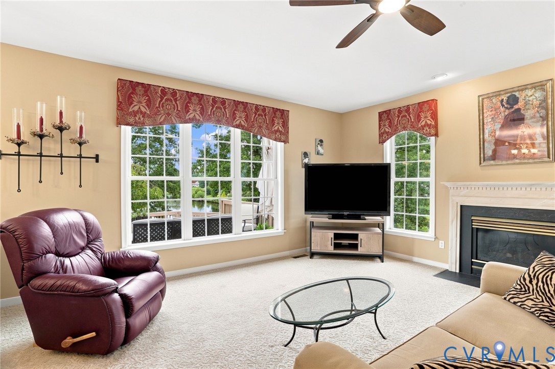 Spacious family room is filled with natural light and features a gas fireplace and views of the lake!