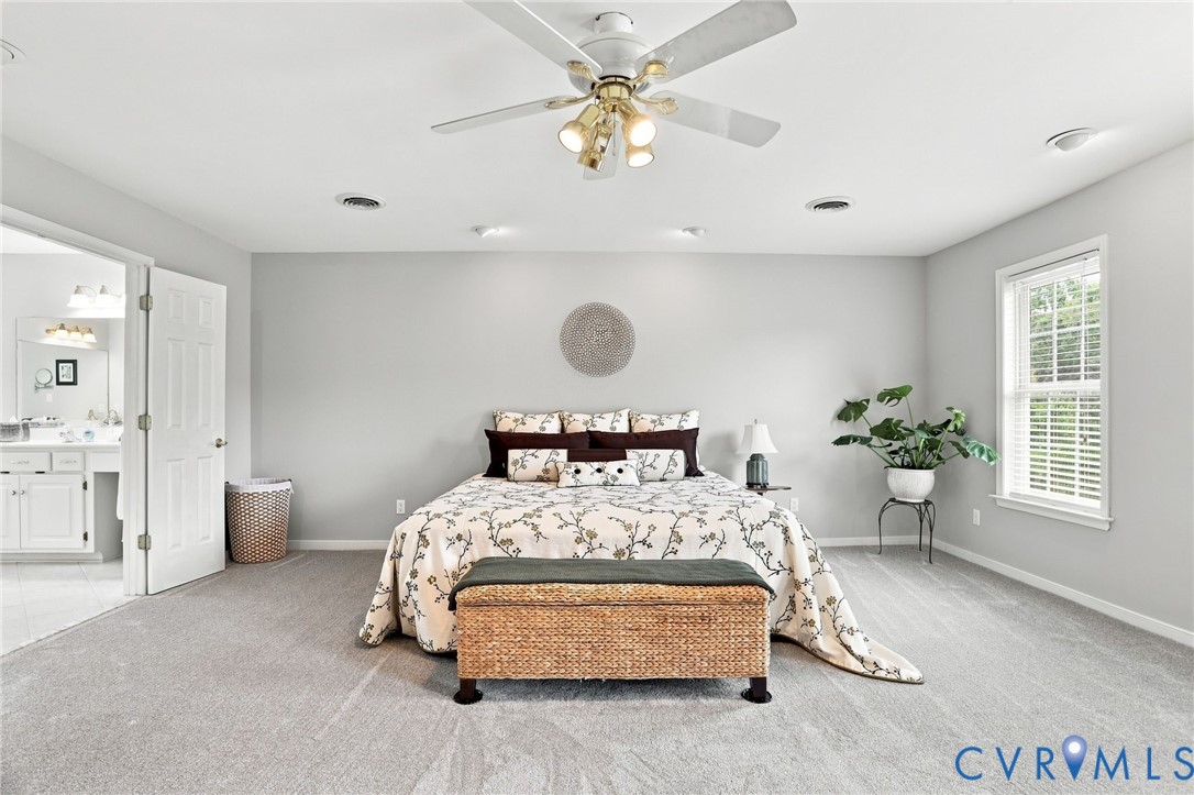Expansive primary suite offers an impressive amount of space with soft neutral finishes and abundant natural light.