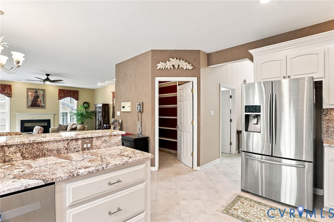 Open kitchen offers generous counter space, a pantry, and easy flow into the family room.