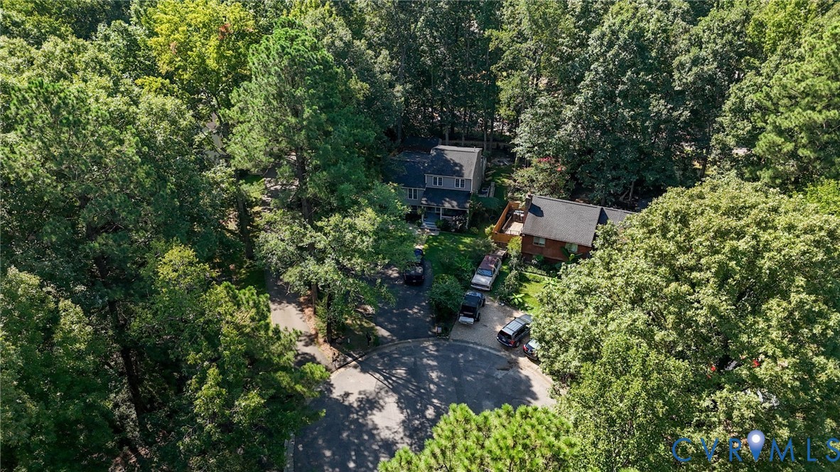 Two-story residence with a gray exterior, a two-story residence with a brown exterior, and a cul-de-sac