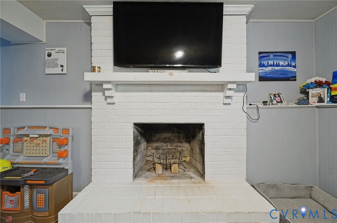 Brick fireplace with a painted white finish, a substantial mantel, and a traditional firebox